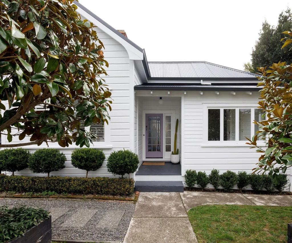 The exterior of the Devonport Villa with a purple front door