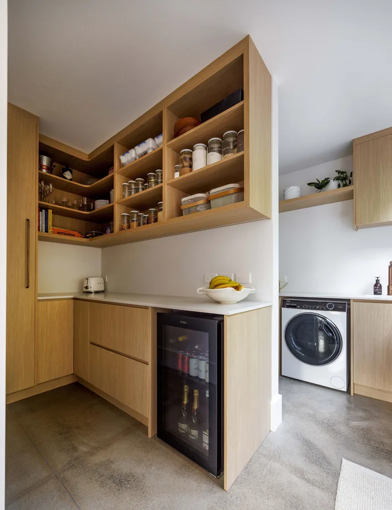 A scullery off the kitchen area with a Haier Beverage Centre, and behind is the laundry with appliances from Haier