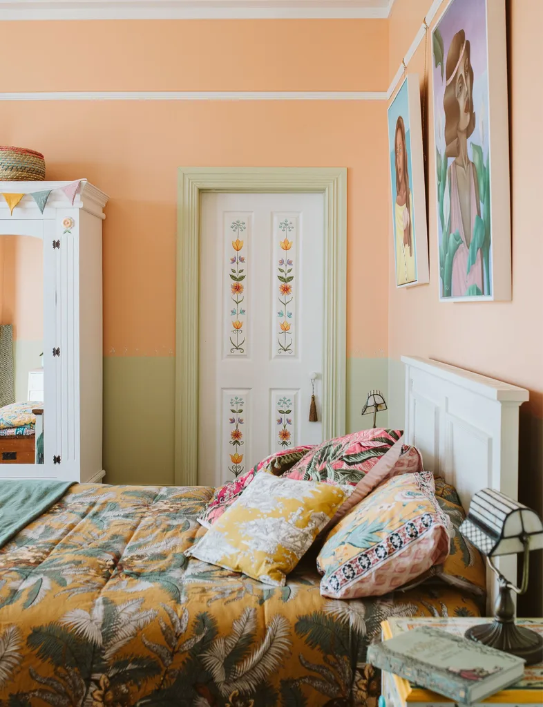 Bedroom with folk art-style plants painted on doors and furniture