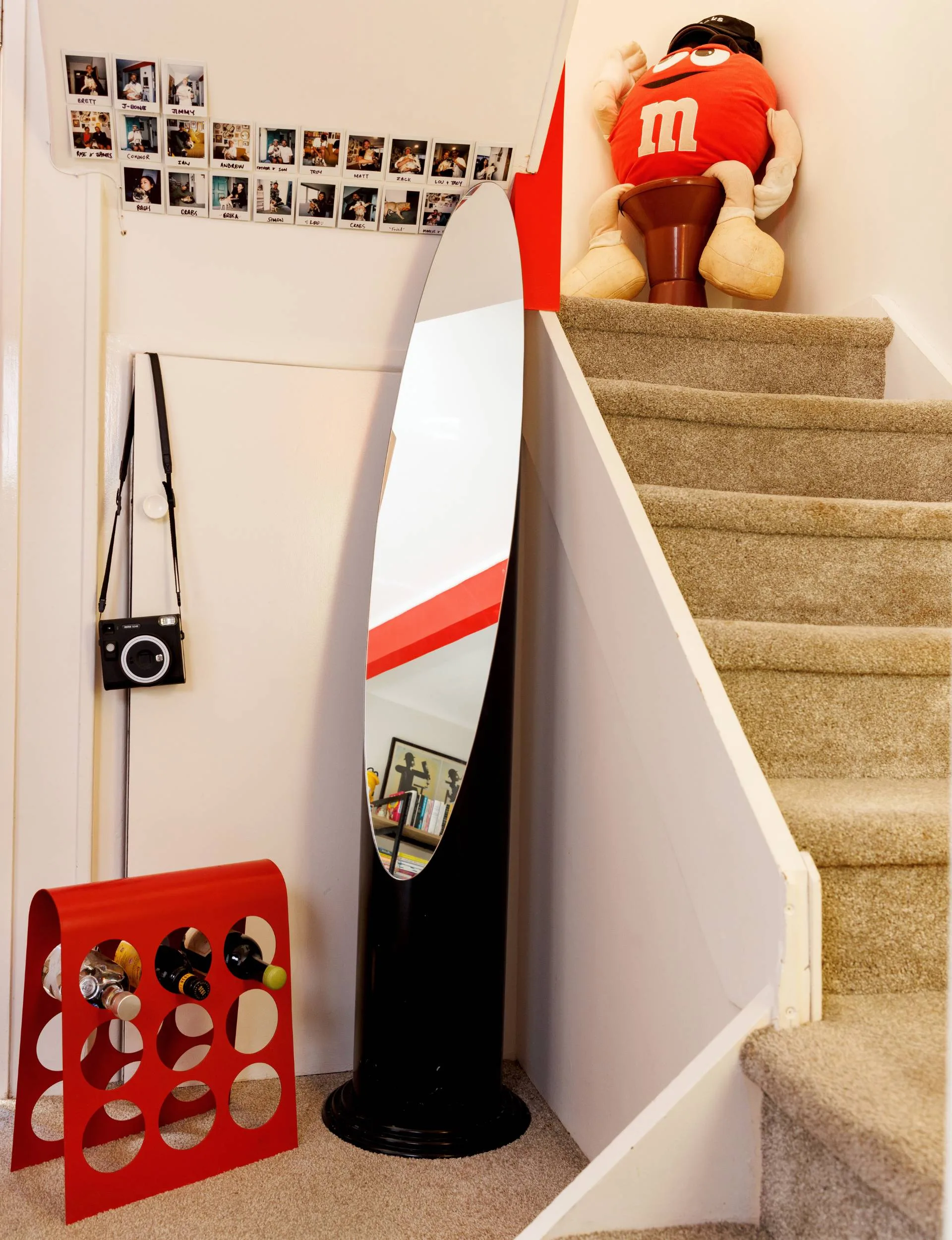 A large oval mirror in the curve of the staircase