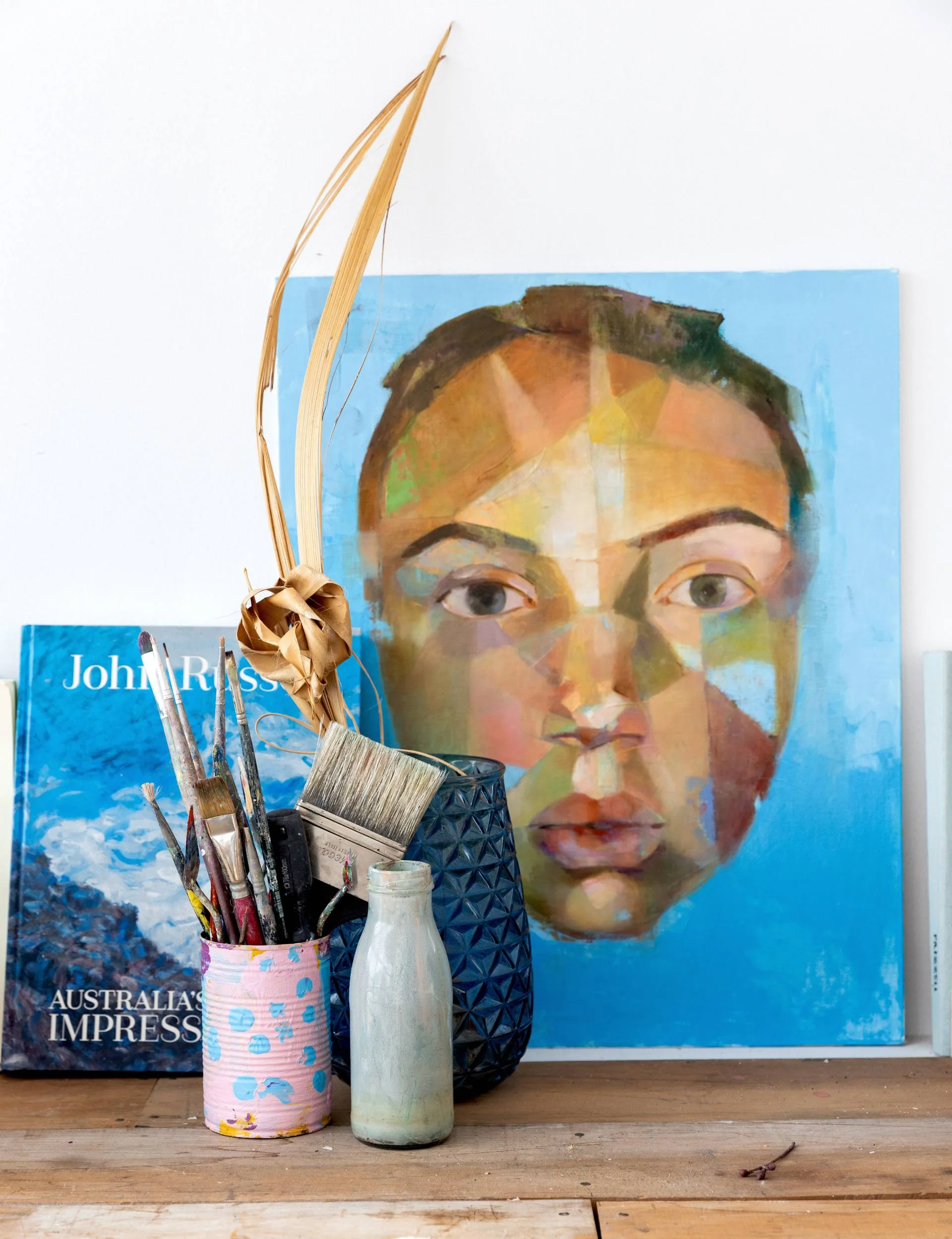 Art displayed with a book and vase