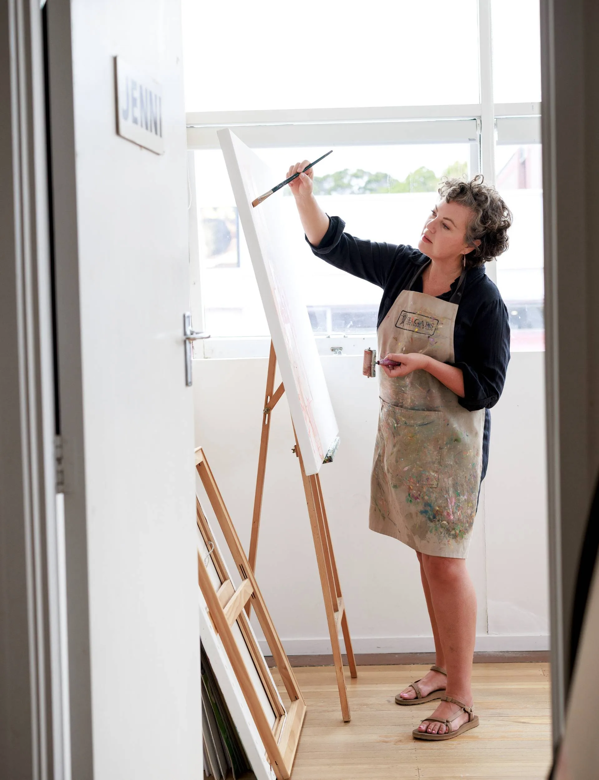 Jenni Stringleman painting in her studio