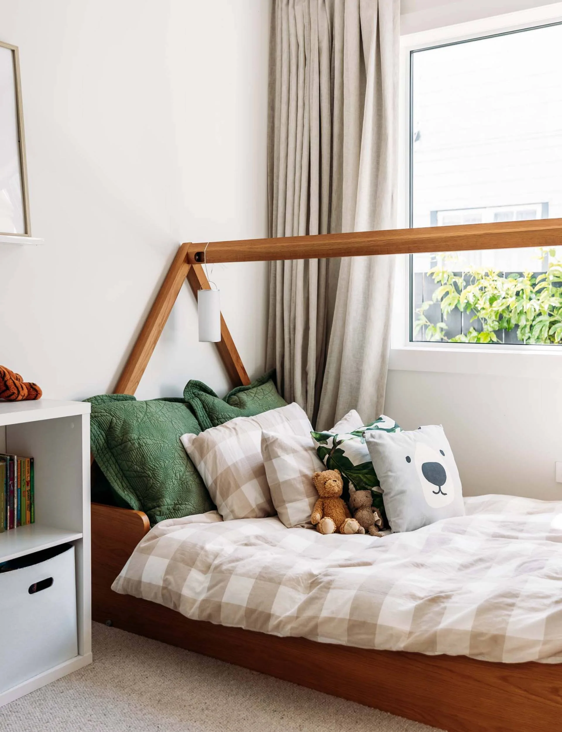 An oak bed frame in the kids room of the renovated Wellington home