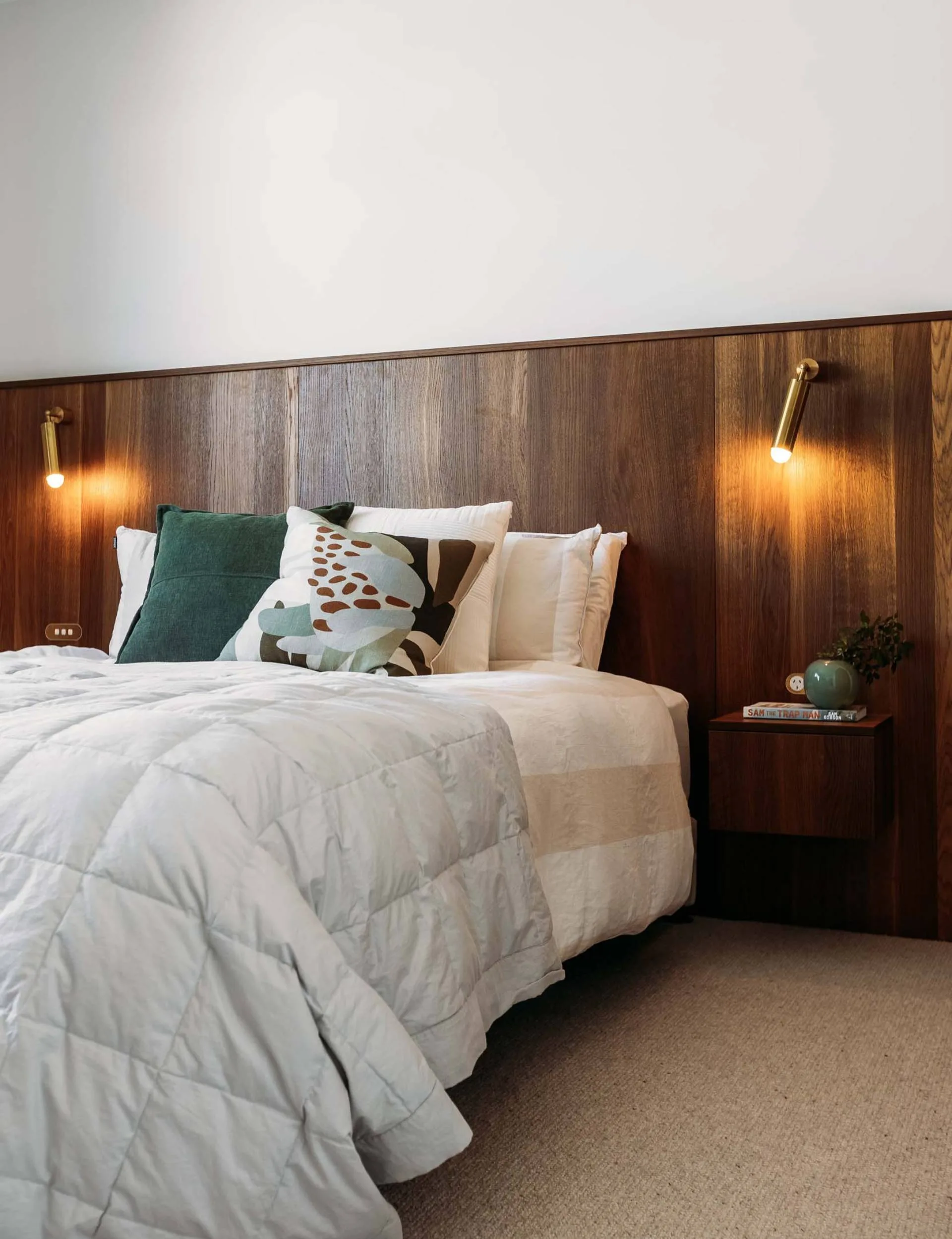A large oak headboard in the master bedroom