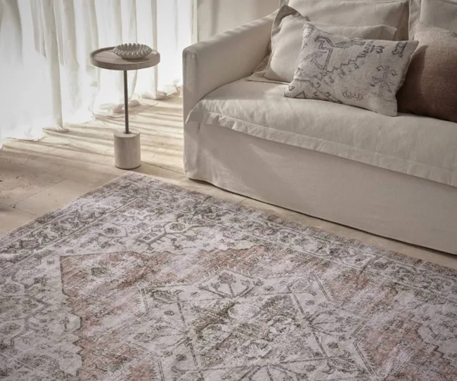 An oriental-inspired washable rug with a white sofa