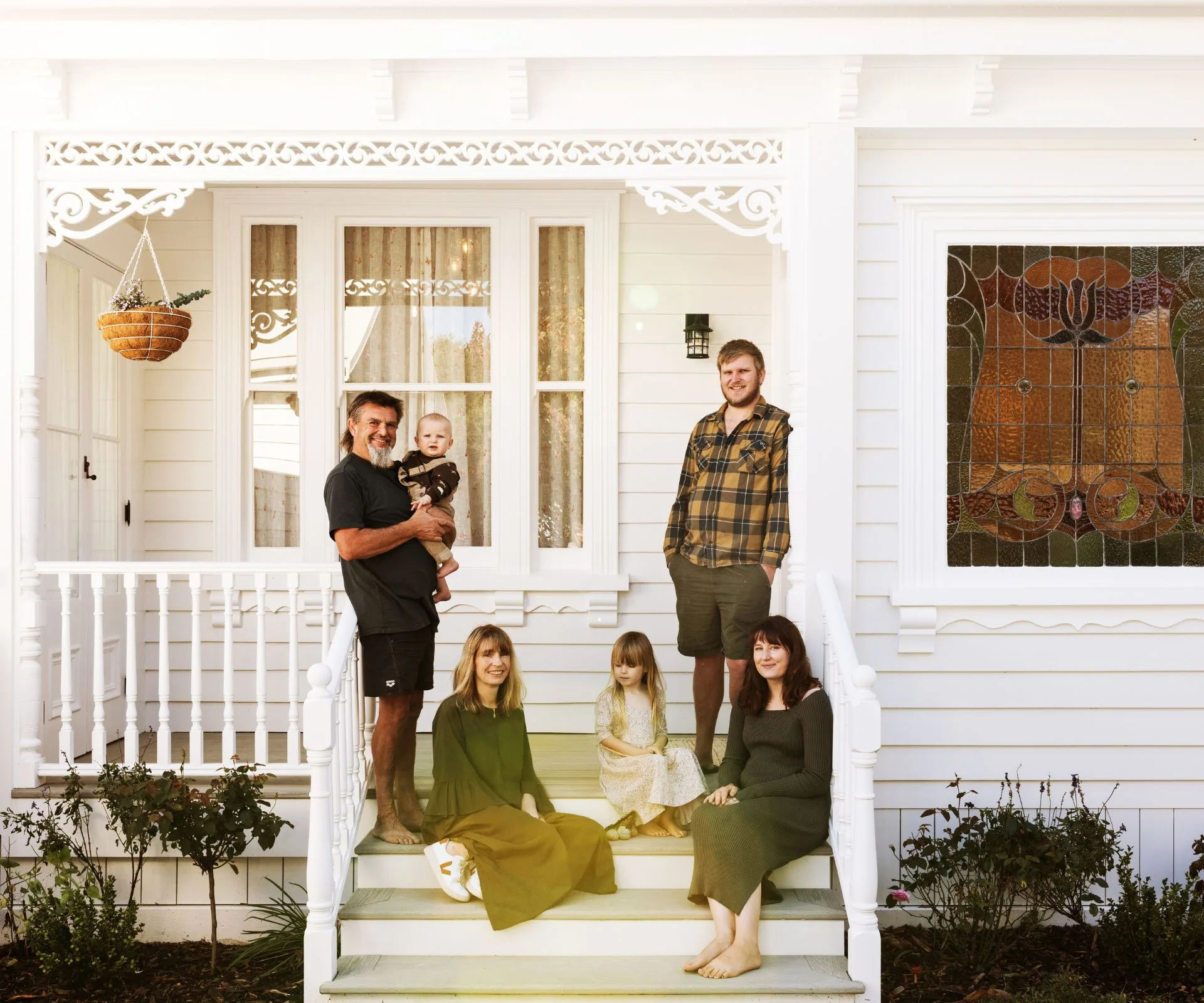 Family sitting in front of villa