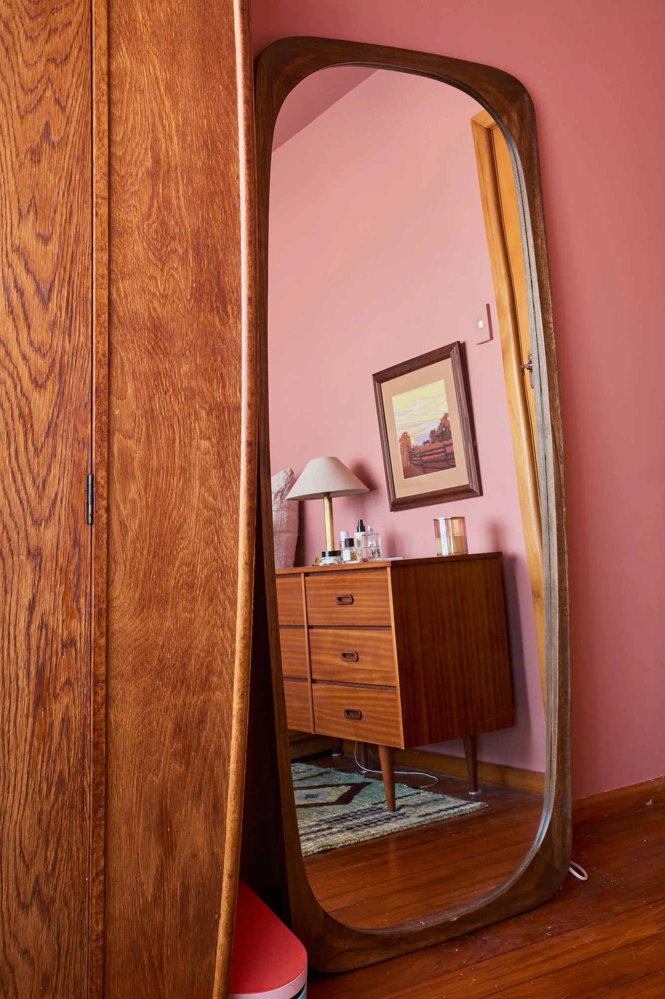 A pink bedroom through a mirror