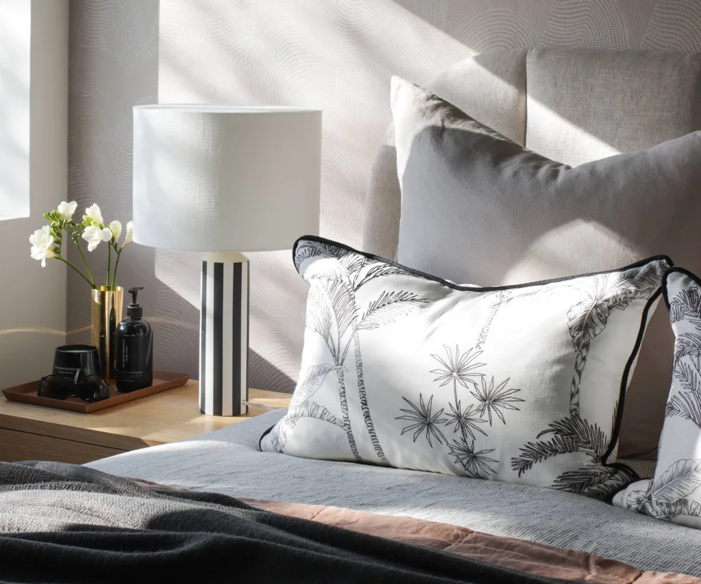 Sunlight gleaming down onto a made bed