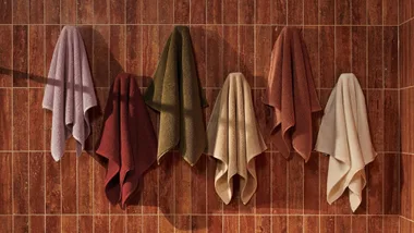 towels hanging on a tiled wall