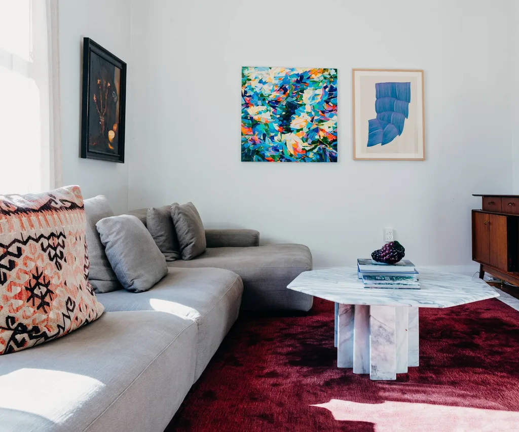 grey couch and burgundy rug in living room
