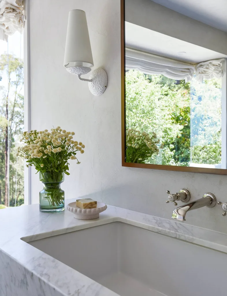 marble sink with vase of flowers