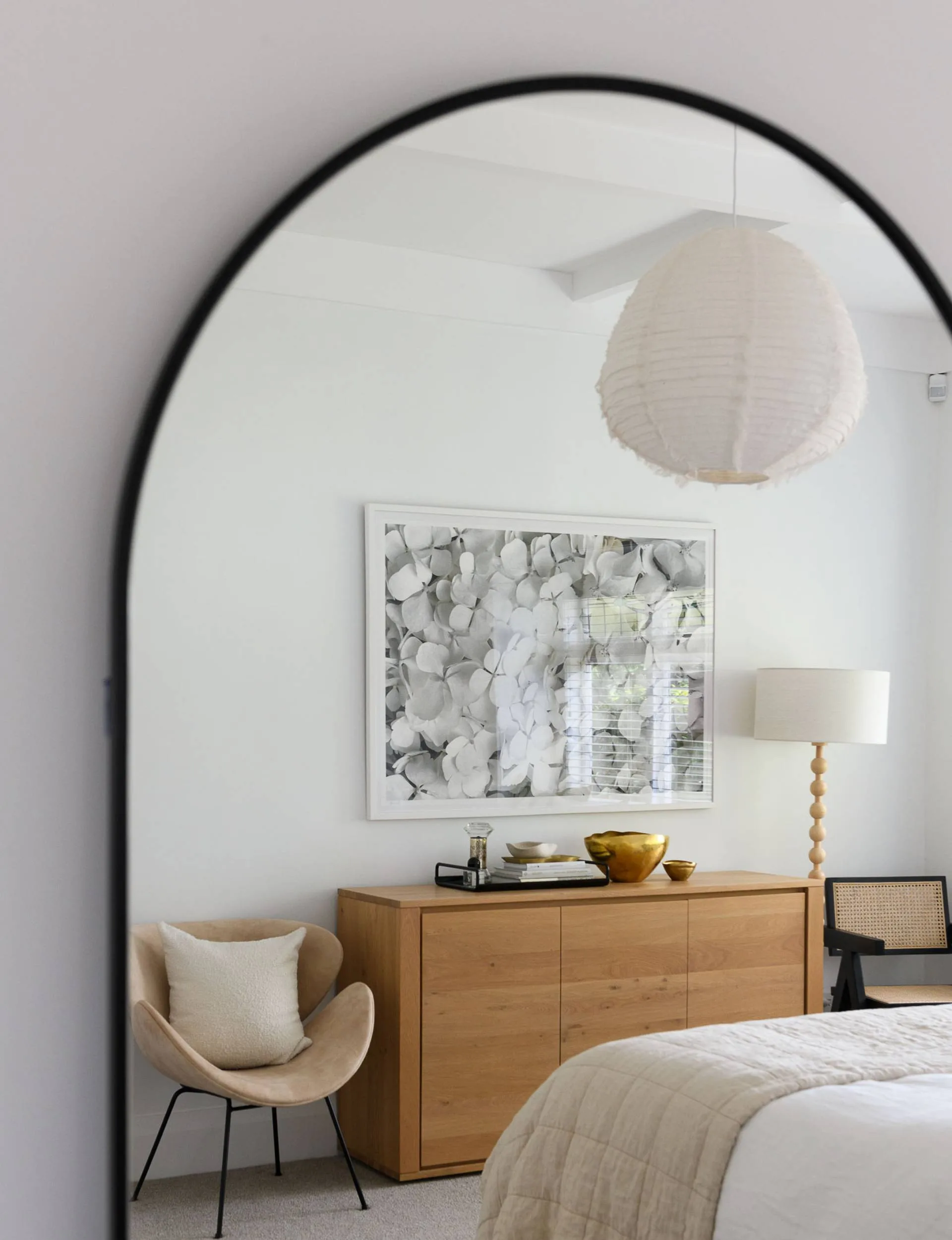 bedroom with mirror and picture frame of flowers