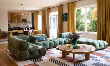A living room with a green couch.
