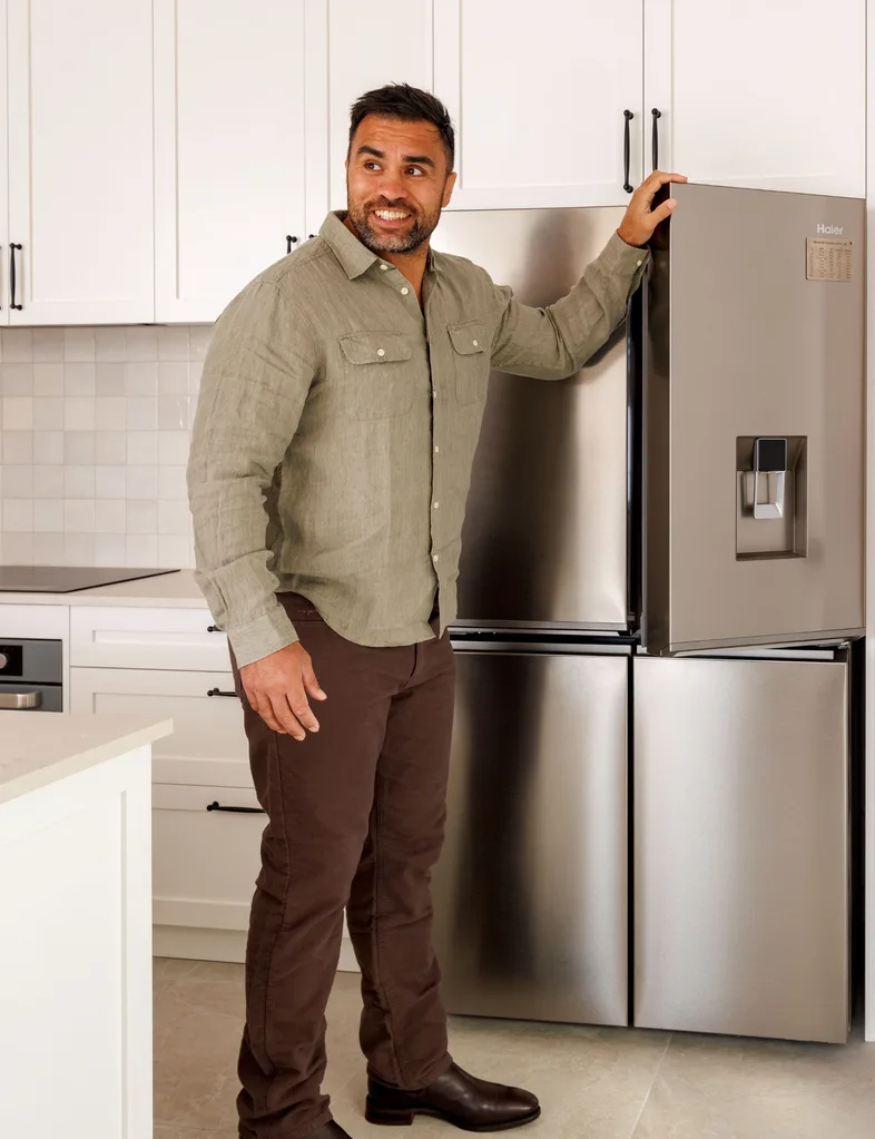 Liam in his kitchen opening the Haier 623L 600 Series Quad Door Refrigerator Freezer