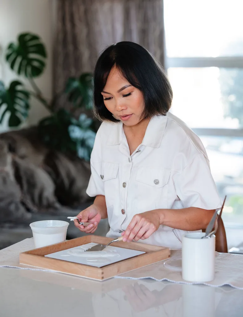 Erica Toh creating one of her relief works