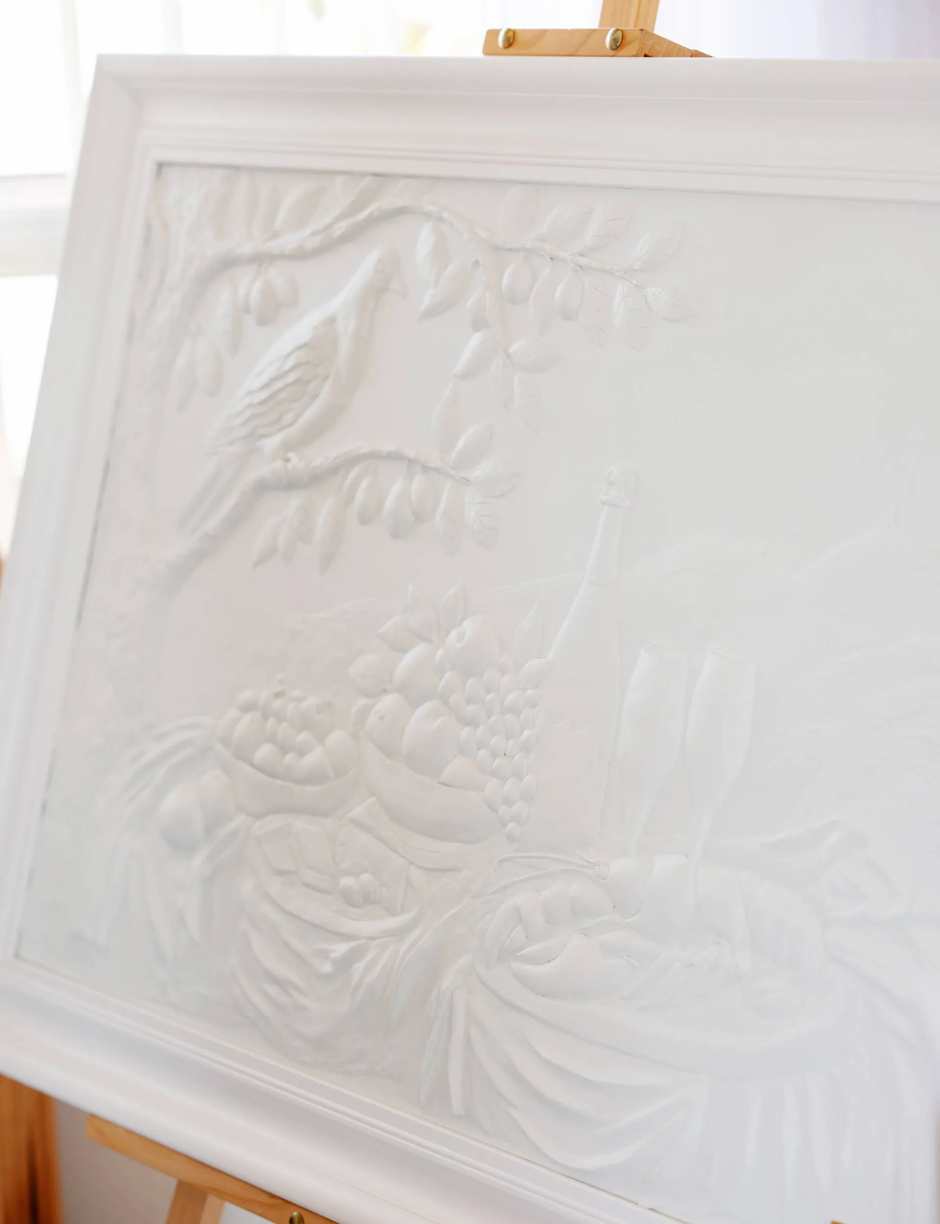 A white relief still life artwork. 