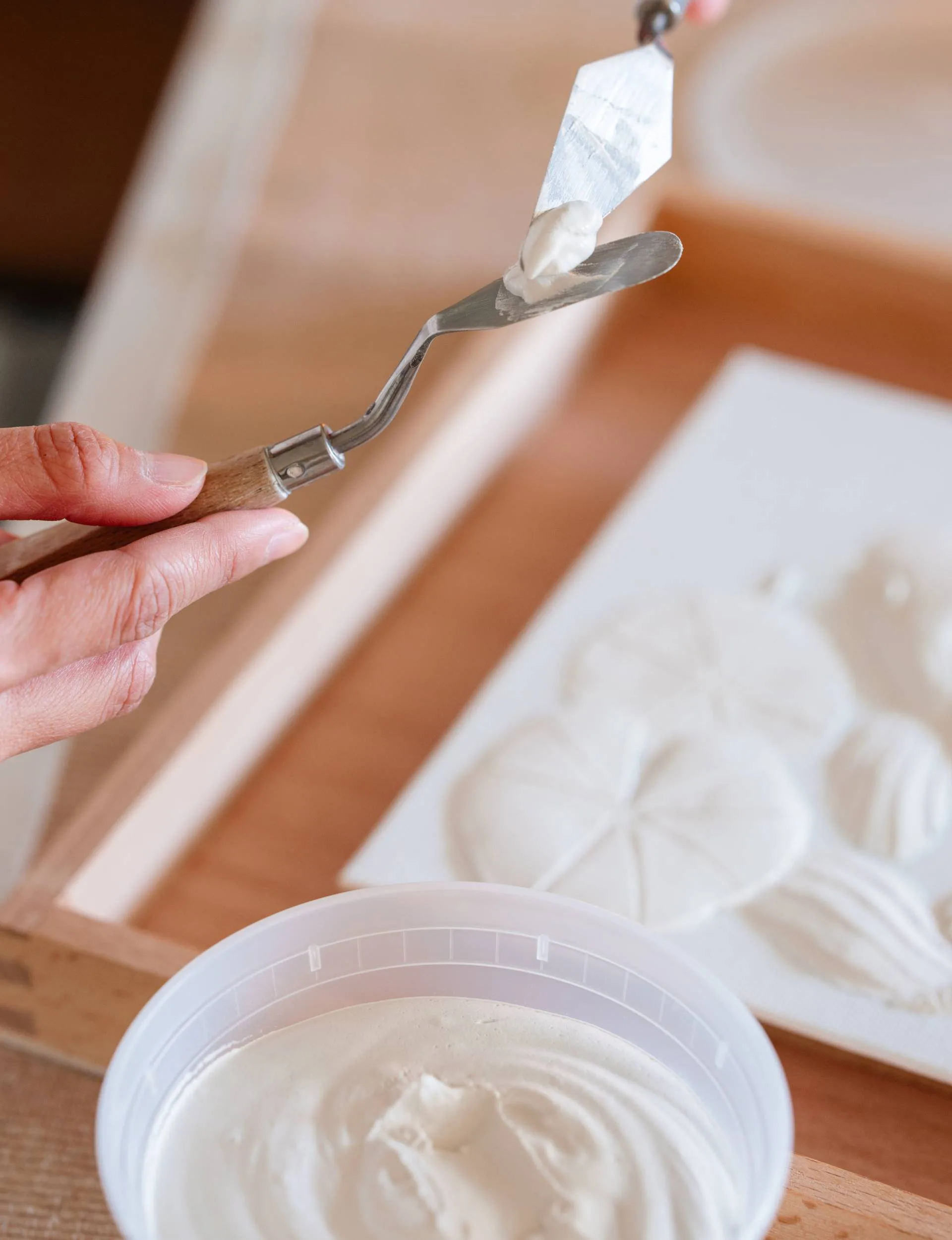 Erica working on one of her white relief works.