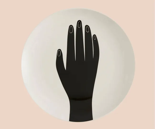 A white plate with a black hand design