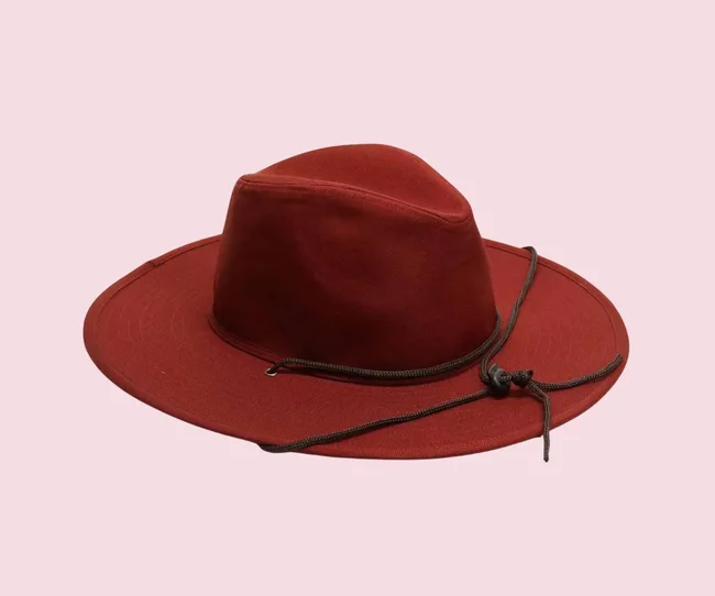 Red sunhat against a pink background