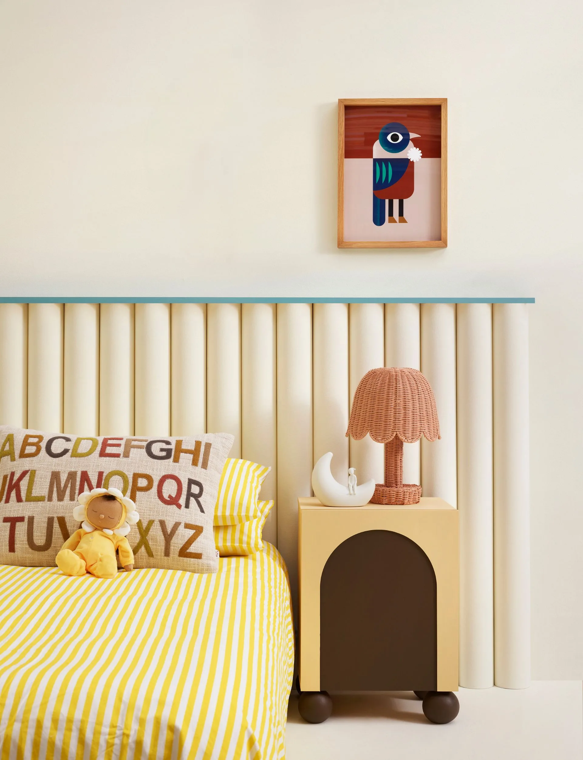This neutral child's bedroom is painted in Resene Half Milk Punch with accent colours of yellow, blue and red