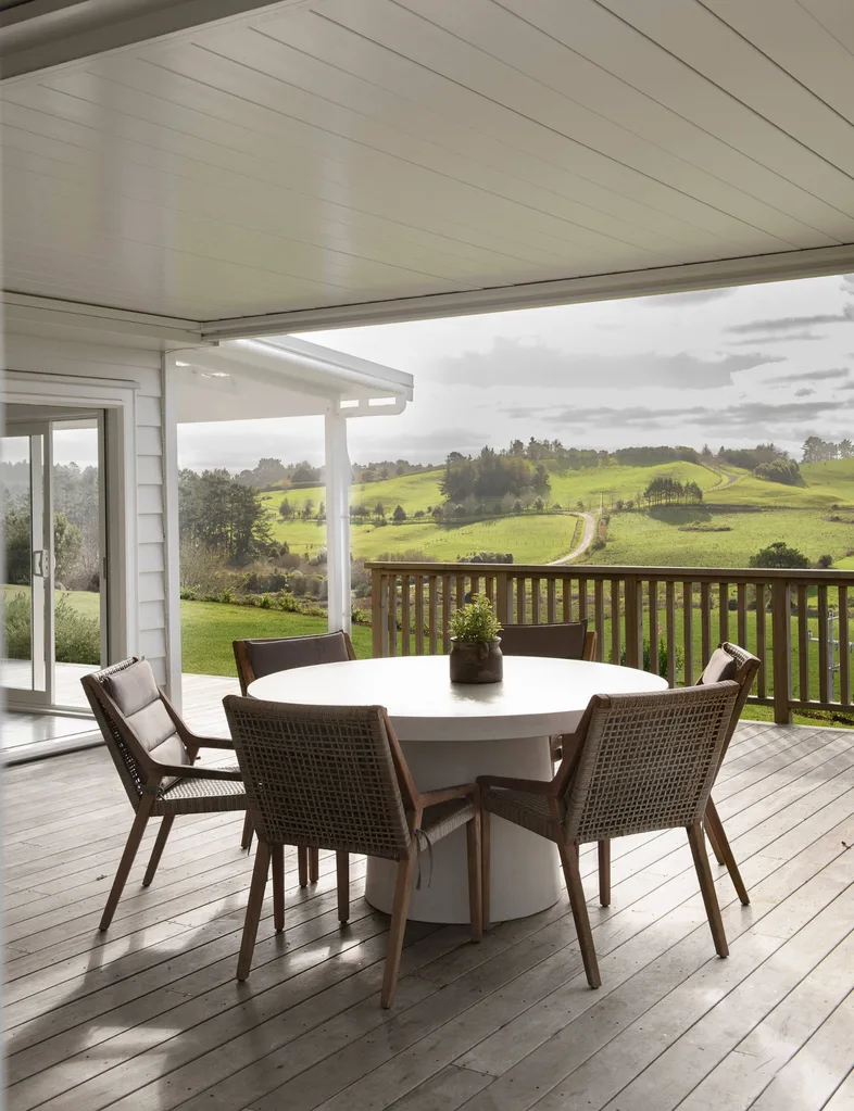 Alfresco dining on a deck with a view of rural countryside.