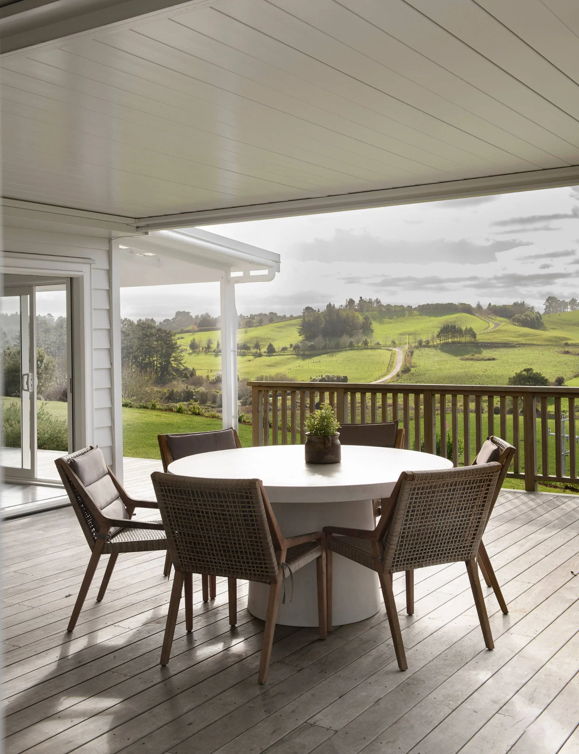 Alfresco dining on a deck with a view of rural countryside. 