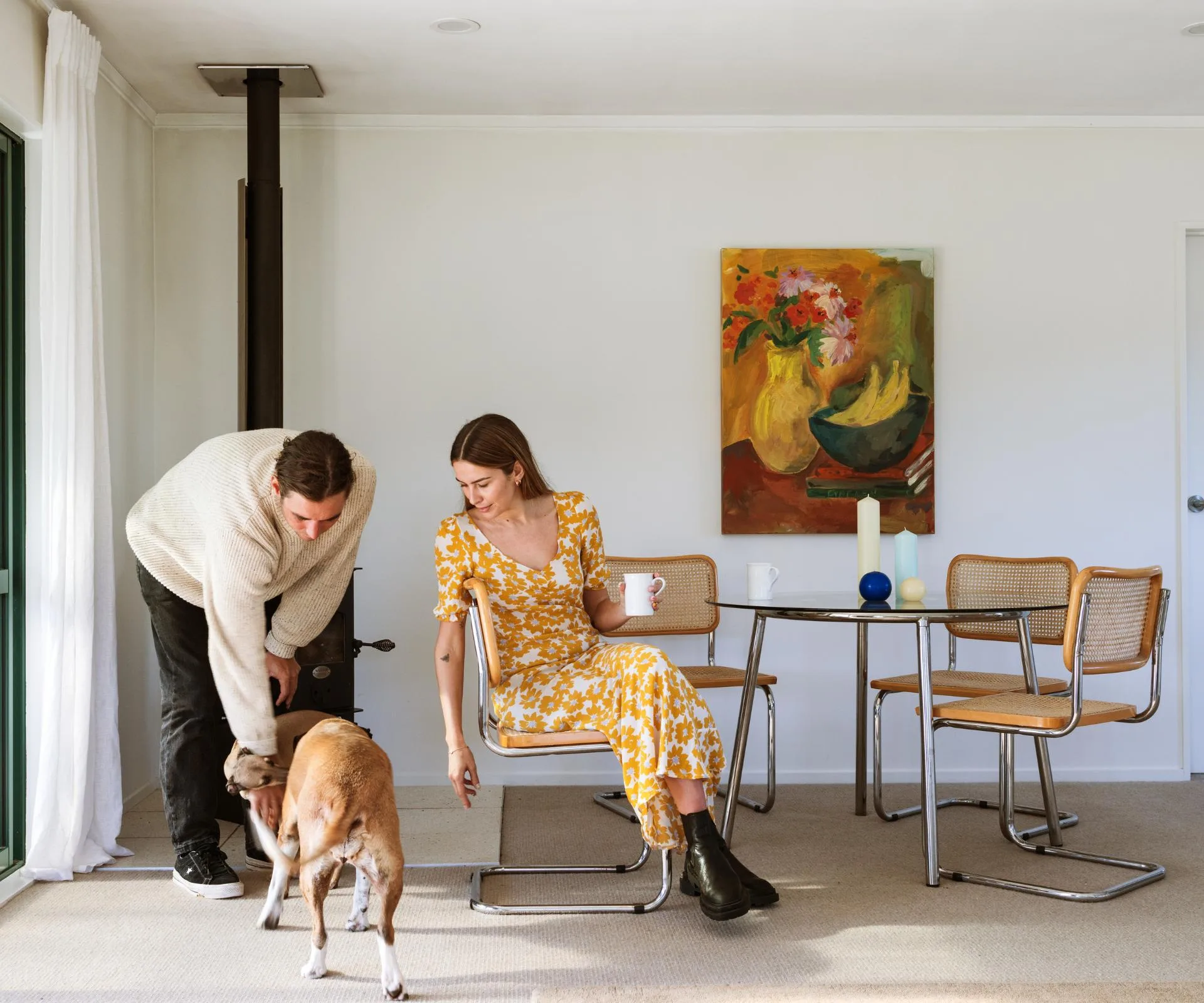 Viarni Bright inside her home with her partner and dog. 