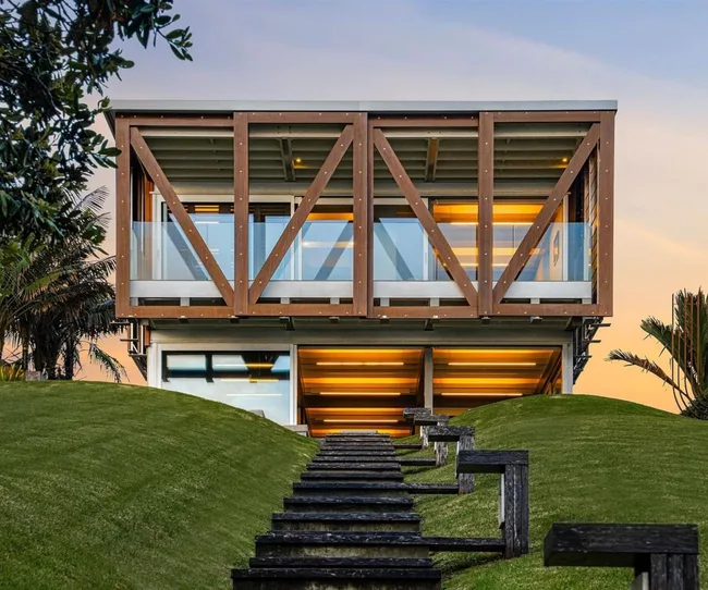 Looking up a yard to a modern box home