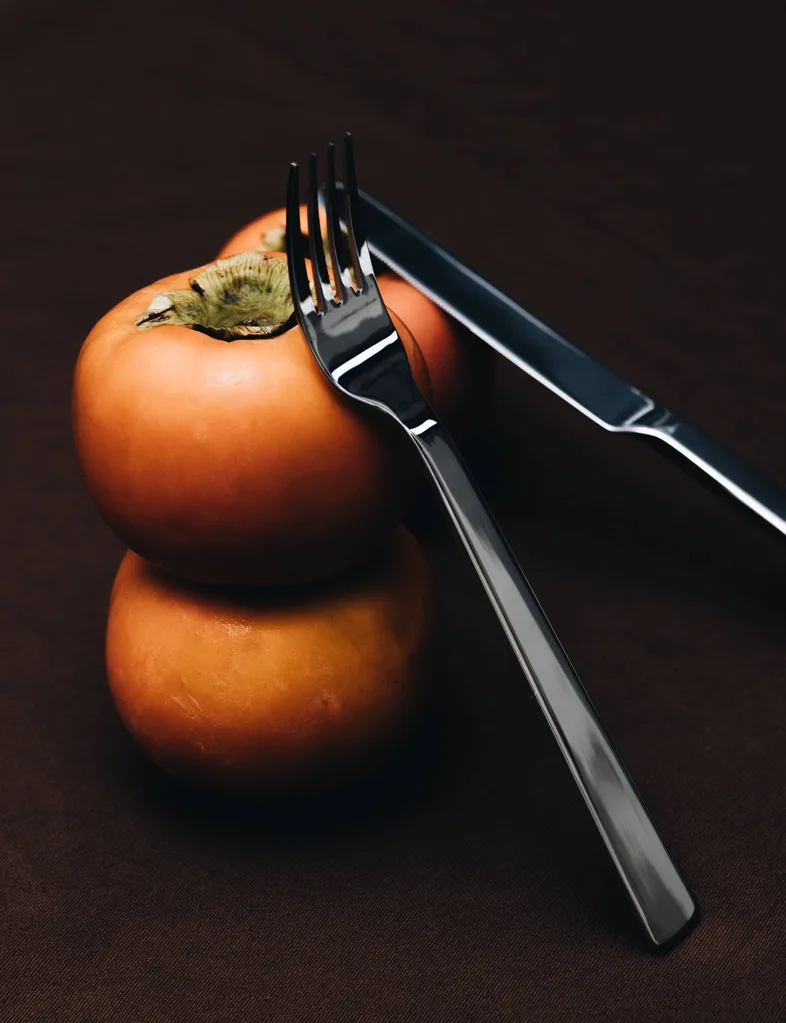 Acme cutlery against a tomato
