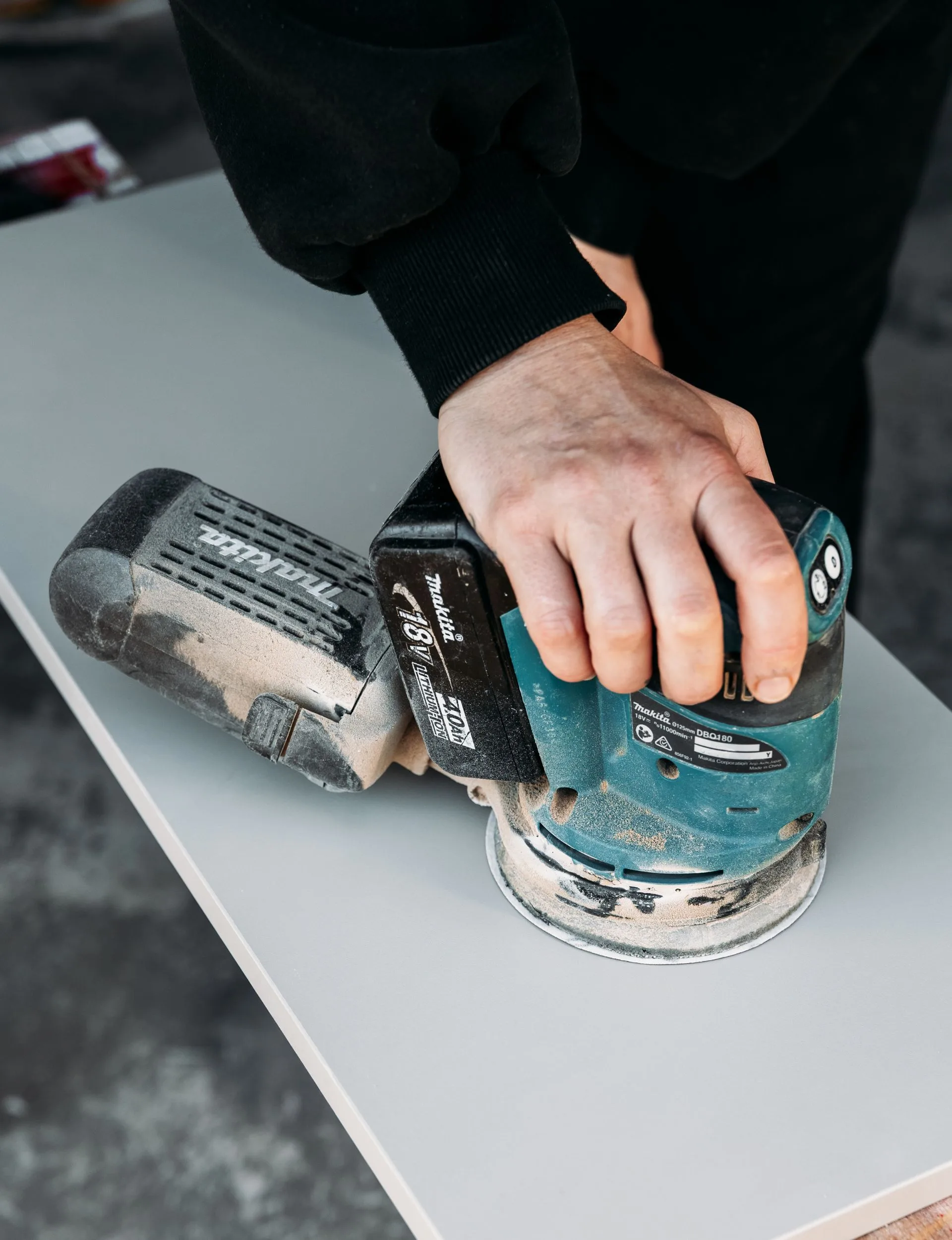 Clean the cupboards and drawer fronts and sand using 220 grit sandpaper