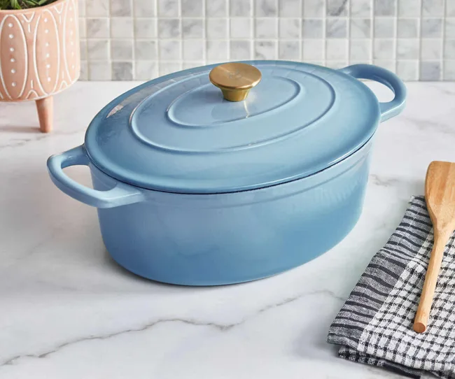 A blue cast iron pot on a kitchen bench