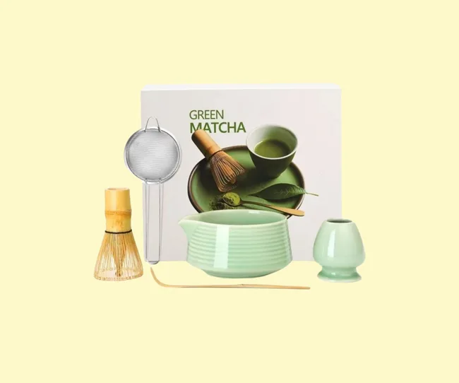 A matcha set including bowl, brush and sieve on a yellow background