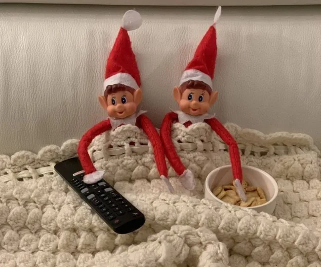 Two elves under a blanket