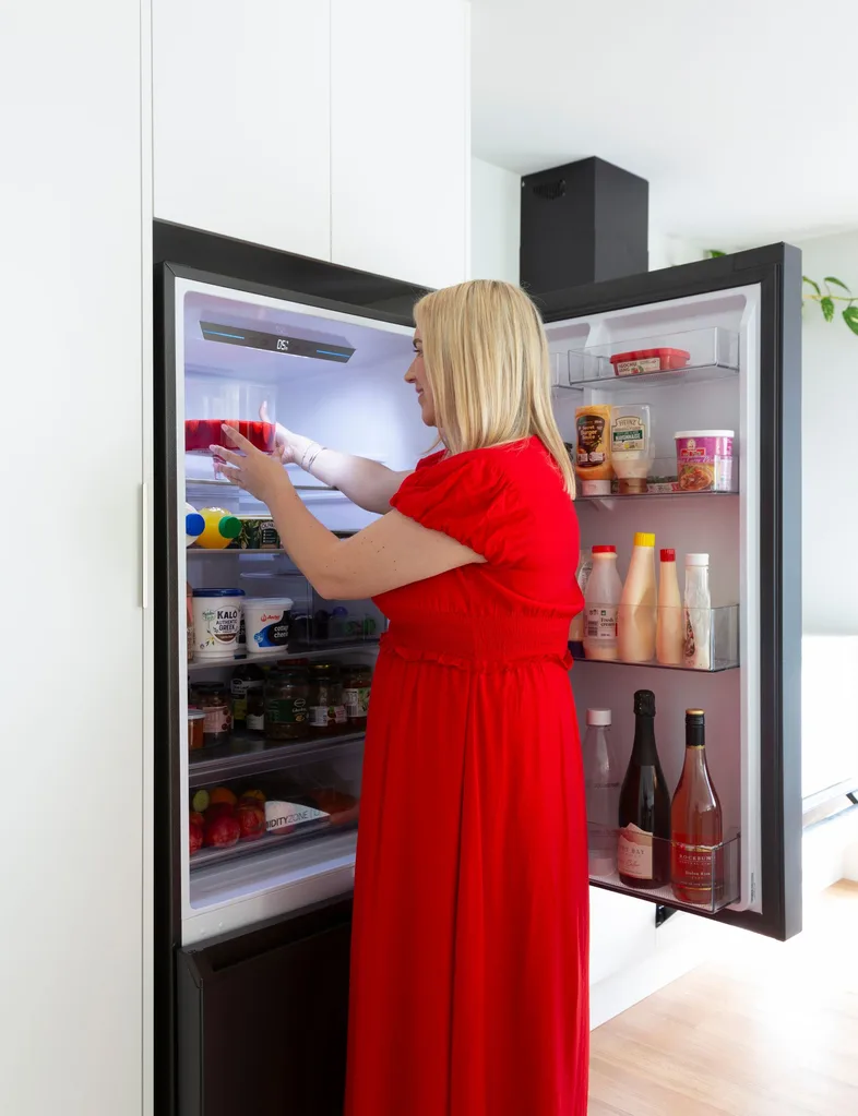 Jana putting trifle away into her Haier fridge
