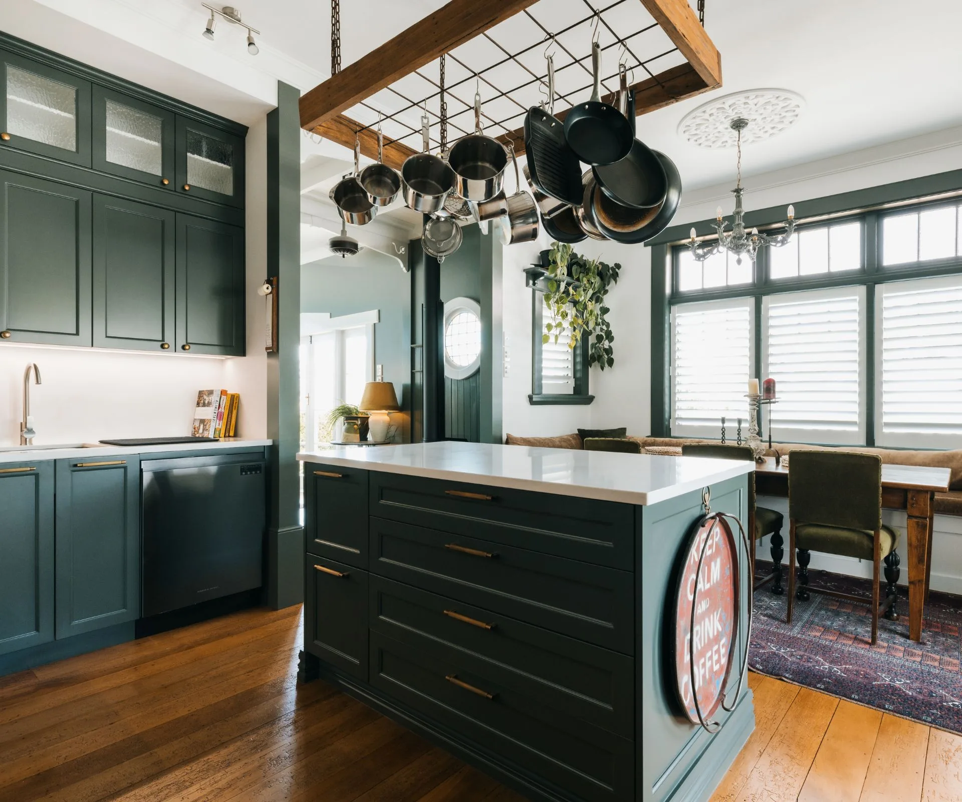 The kitchen cabinetry is painted in Resene Double Mangrove, a sophisticated muddy green, with the contrasting neutral of Resene Quarter White Pointer