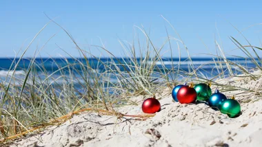 Christmas baubles on a beach