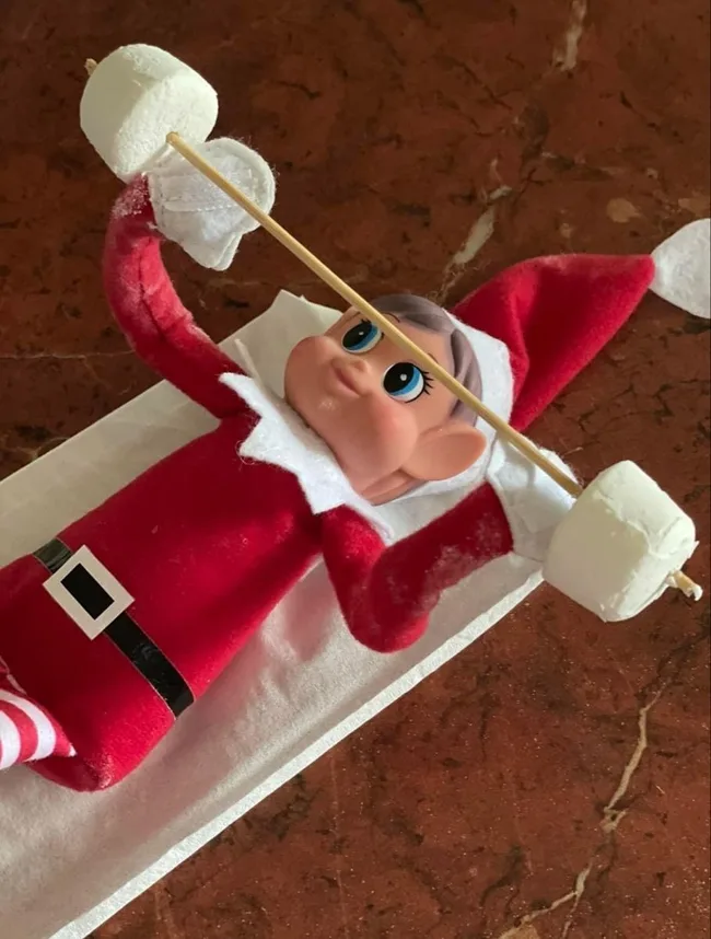 Elf doing chest presses with marshmallows
