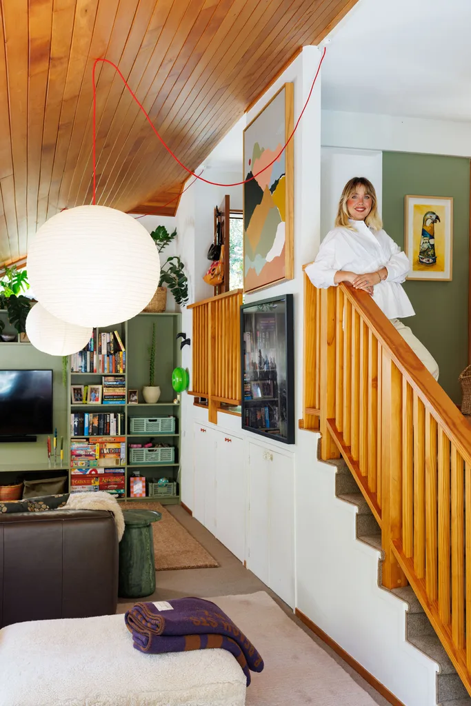 Jazmyne van Gosliga on the stairs of her Beach Haven home