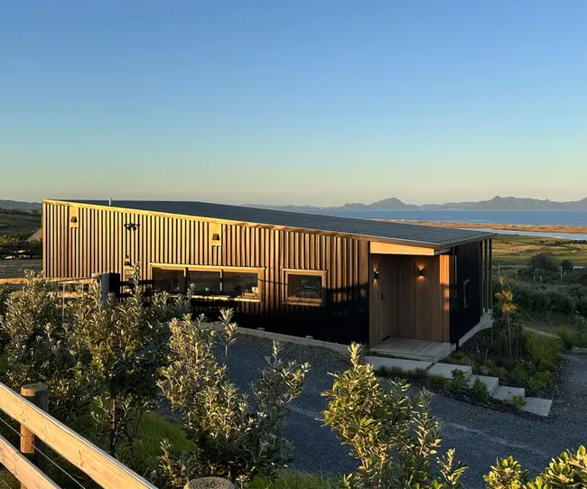 A black shed overlooking sea views