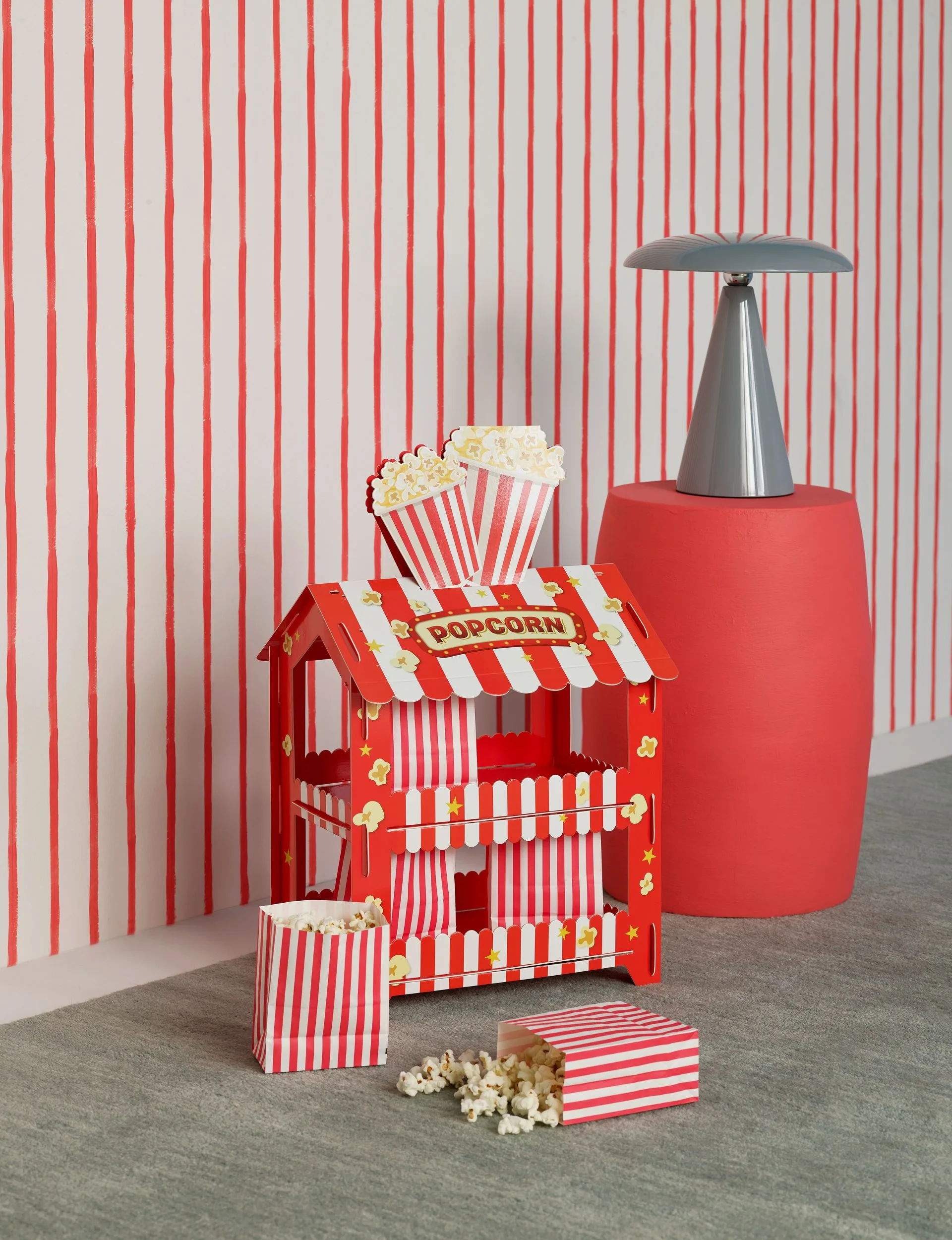 Red and white stripes on the wall continue the circus theme throughout this room