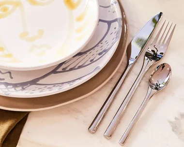 knife, fork and spoon laid beside a plate and bowl