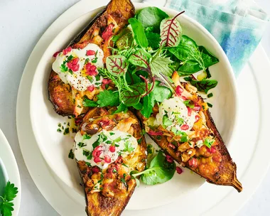 Stuffed eggplants filled with shredded chicken and topped with mozzarella and herbs