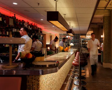 Merivale's Good Luck Restaurant Lounge bar in Sydney CBD with bar staff and waiter walking towards camera
