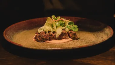 A plate with sliced steak on it.