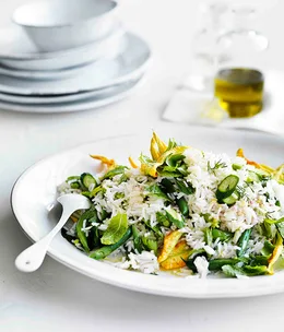Rice salad with zucchini flowers, peas, beans and mint