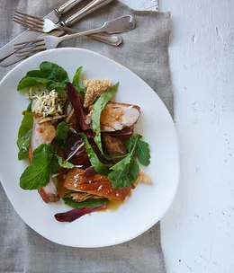 Roast suckling pig with bitter greens and apple