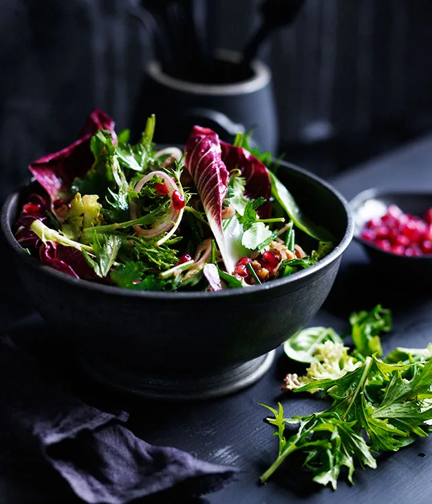 Mixed tender leaf salad with pomegranate and walnuts