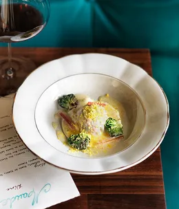 Duck raviolo with finger lime beurre blanc and caramelised Brussels sprouts