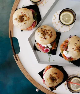 Onion bialys with sugar-cured trout and green peppercorn cream