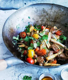 Stir-fried beef with baby corn, tomato and sesame